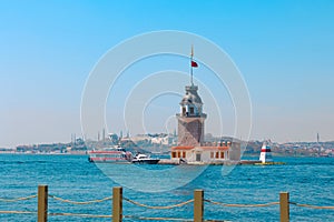 Maiden's Tower aka Kiz Kulesi with a tour boat and cityscape of Istanbul photo