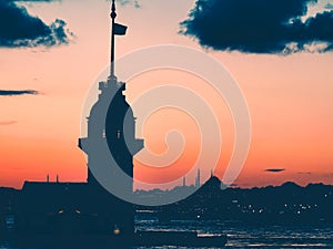 Maiden`s Tower Black silhouette against the background of the red sky and Istanbul at sunset in the evening at dusk