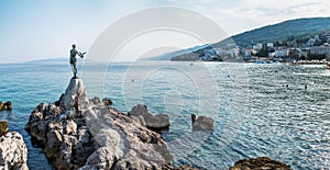 The Maiden with the Seagull. The statue is the symbol of  Opatij, Croatia. Beautiful panoramic view of Opatija town
