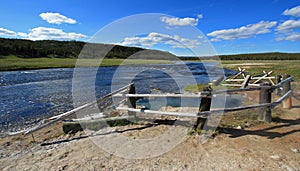 Maidens Grave Hot Spring flowing into the Firehole River in Yellowstone National Park in Wyoming USA