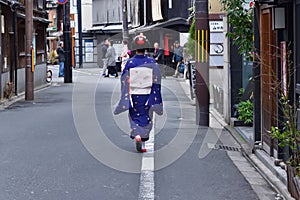 Maiko girl on the way of Gion alley, Kyoto Japan.