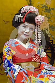 Maiko in red kimono with gold background