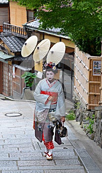 Maiko walking in Kyoto's street, Japan