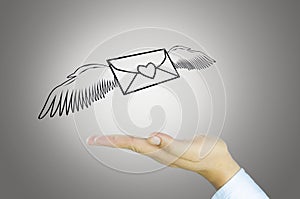 Mail with angel wing on Human hand