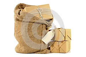 Mail bag or sack with stack of wrapped packages, isolated on white