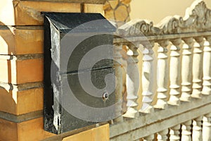 Mail box on fence outdoors