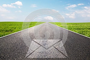 Mail, message symbol on long straight road, highway.