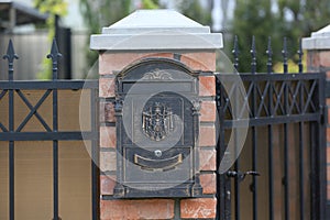 Mail metal box on a brick wall. Close-up