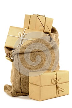 Mail sack or post bag with several brown paper wrapped parcels isolated on white background photo