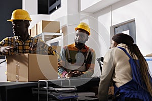 Mail sorting center workers preparing parcel for delivery