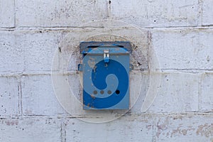 Mailbox blue in retro style on brick wall. old iron