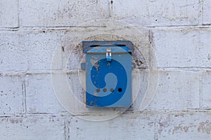 Mailbox blue in retro style on brick wall. old iron