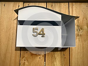 Mailbox with house number 54. front view.