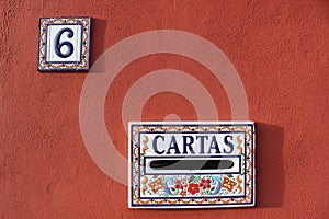 Cartas Mailbox and house number plate in Spain, colorful red white blue color design 6 six