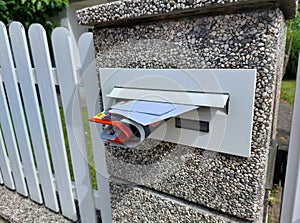 mailbox with letters and advertise on palisade