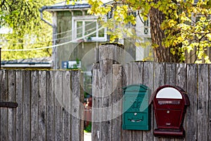 Mailboxes on the fence of a private house in the countryside