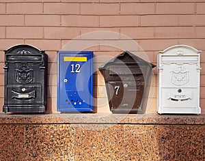Mailboxes on the wall of a brick house