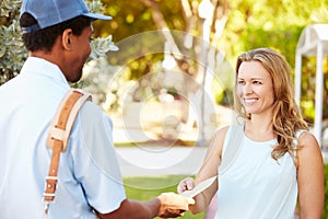 Mailman Delivering Letters To Woman