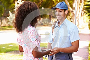 Mailman Delivering Letters To Woman