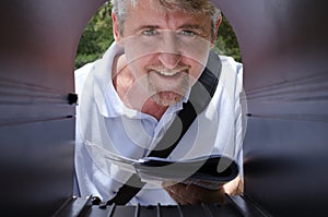 Mailman making a delivery of letters to a mailbox