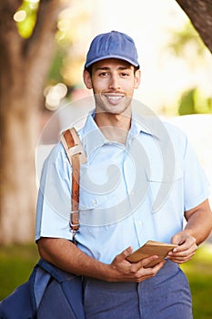 Mailman Walking Along Street Delivering Letters