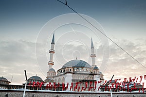 Main building of the Taksim Mosque, also called Taksim camii, with turkish flags. photo