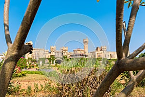 Main buildings of Bangalore Palace, With blurred tree branches in the foreground, Bangalore, Karnataka, India.