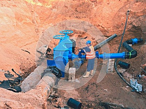 Main City water supply pipeline. Technical staff in reflective vest underground