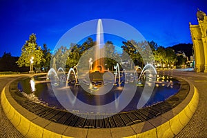 Main colonnade in the small west bohemian spa town Marianske Lazne Marienbad and singing fountain at night - Czech Republic