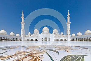 The main courtyard of the Sheik Zayed grand mosque in Abu Dhabi with the prayer hall at the far end