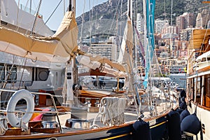 A main deck of sail yacht in classic style, lot of huge yachts are in port of Monaco at sunny day, Monte Carlo