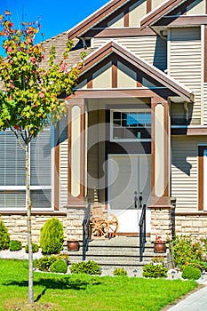 Main entrance of big family house with concrete door steps in front