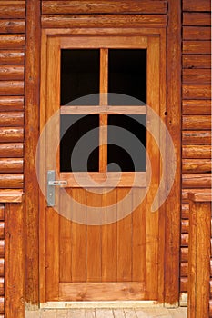 Fir wood door. The main entrance in a cottage