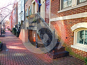 Main entrance door to house. Exterior of a brick house with carved, cast-iron steps at the entrance