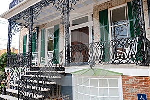 Main entrance door to house. Exterior of a brick house with carved, cast-iron steps at the entrance