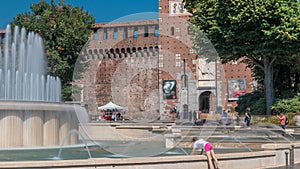 Main entrance to the Sforza Castle - Castello Sforzesco and fountain in front of it timelapse, Milan, Italy