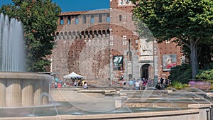 Main entrance to the Sforza Castle - Castello Sforzesco and fountain in front of it timelapse, Milan, Italy