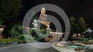 Main entrance to the Sforza Castle and tower - Castello Sforzesco night timelapse , Milan, Italy photo