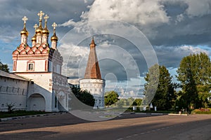 Main entrance, watchtower and dramatic clouds.