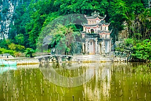 Main famous temple close to lake of the Bich pagoda complex, Tam Coc, Ninh Binh, Vietnam