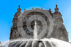 Main fountain with splashes of water in Ferrari Square against backdrop of beautiful architecture of city. Piazza de