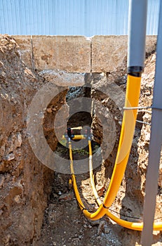 Main gas pipe and two connections with signal cables connected using fittings for electrofusion welding.