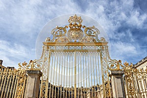 Main golden door in exterior facade of Versailles Palace, Paris, France