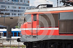 Red electric locomotive of Slovenian Railways shunting on Ljubljana train station platform getting ready for departure. photo