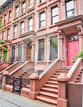 Main ladder and entry door. New york Harlem buildings. Brown houses. NYC, USA