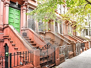 Main ladder and entry door. New york Harlem buildings. Brown houses. NYC, USA