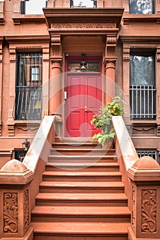 Main ladder and entry door. New york Harlem buildings. Brown houses. NYC, USA