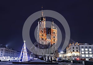 Main market square in Krakow with St. Mary`s Basilica before Christmas at night