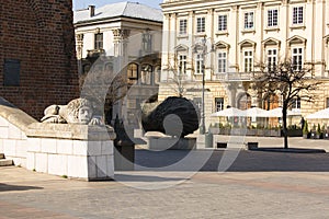 Main Market Square, stone sculptures of a lions in front of the entrance of Town Hall Tower, Krakow, Poland