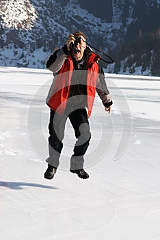 Main in red with photo jumping on winter lake